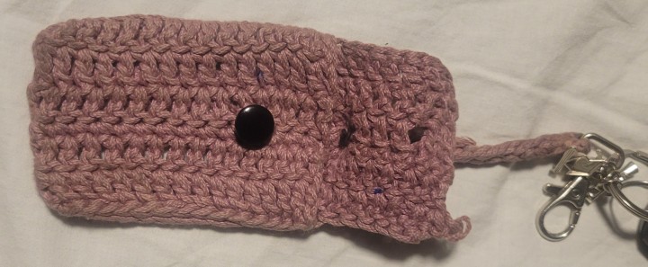 The back of the crochet keychain holder. It includes an opening for the keycard barcode